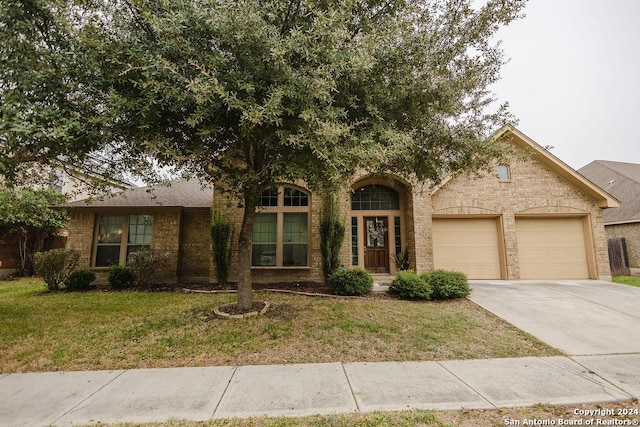 view of front of home with a front lawn and a garage