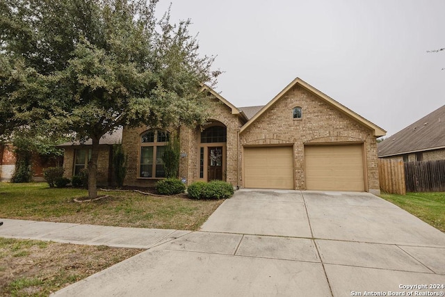 view of front of home featuring a garage and a front lawn