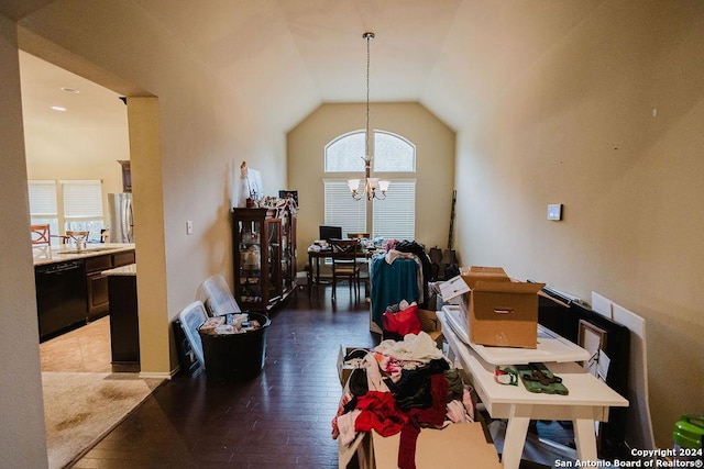 dining room featuring a notable chandelier, plenty of natural light, wood-type flooring, and lofted ceiling