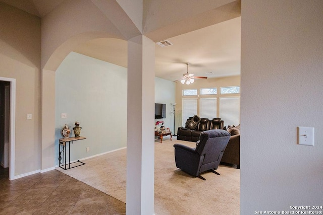 carpeted living room with ceiling fan