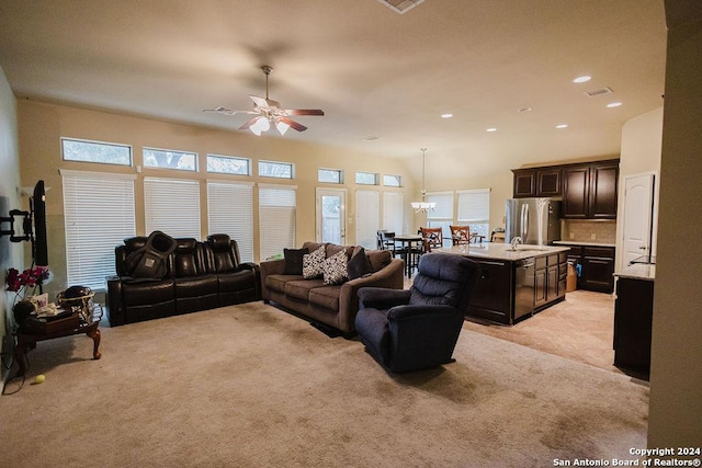 carpeted living room with ceiling fan and sink