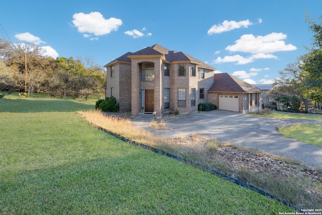 view of front facade featuring a front lawn and a garage