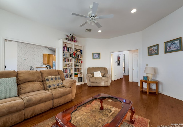 living room featuring ceiling fan and dark hardwood / wood-style flooring