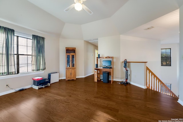 living room with a healthy amount of sunlight, ceiling fan, dark wood-type flooring, and vaulted ceiling