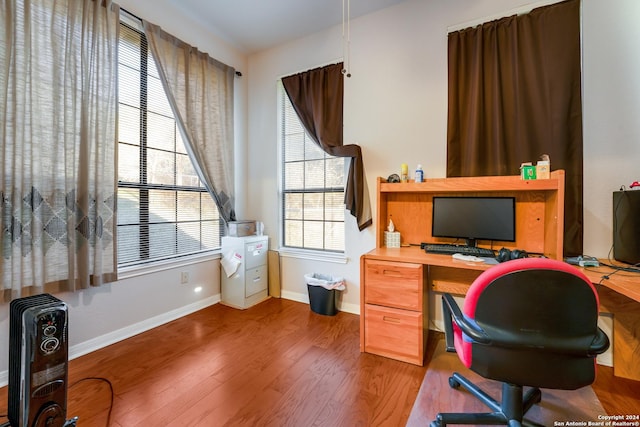 office space with plenty of natural light and wood-type flooring