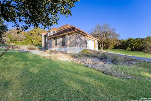 view of home's exterior featuring a garage and a lawn