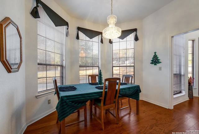 dining room featuring a notable chandelier and dark hardwood / wood-style floors