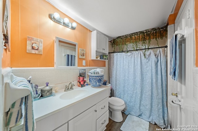 bathroom featuring hardwood / wood-style flooring, vanity, toilet, and walk in shower