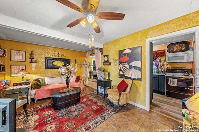 living room featuring ceiling fan and light tile patterned floors