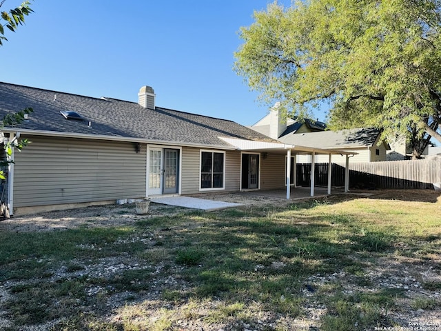 rear view of house with a patio area and a yard