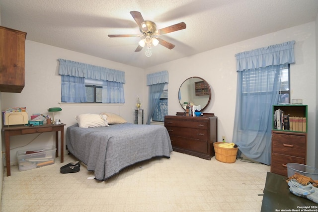 bedroom featuring a textured ceiling and ceiling fan