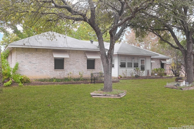 rear view of property with a lawn