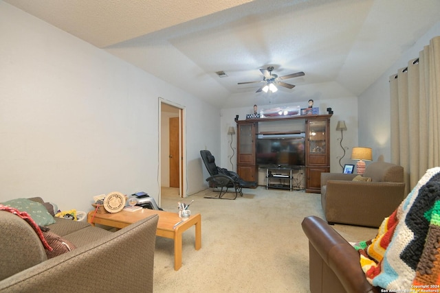 living room featuring light carpet, a textured ceiling, vaulted ceiling, and ceiling fan