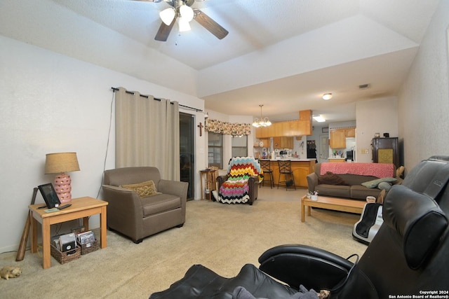 living room featuring light carpet and ceiling fan with notable chandelier