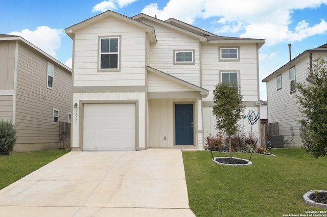 view of front property with cooling unit, a front yard, and a garage