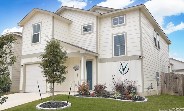 view of front of property featuring a garage and a front lawn