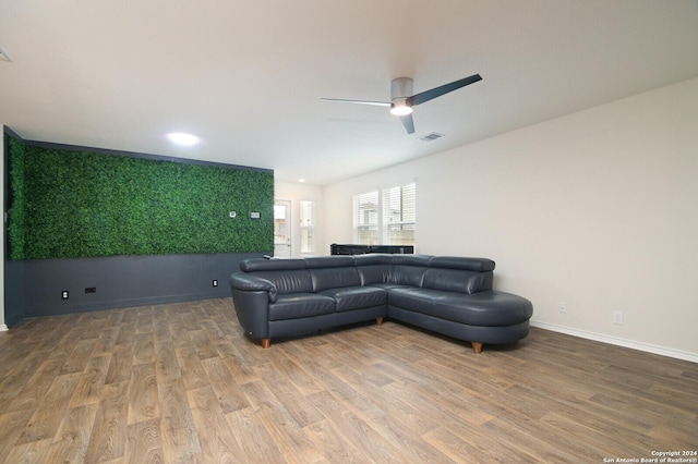 living room with ceiling fan and wood-type flooring