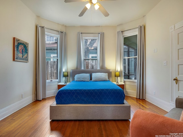 bedroom with ceiling fan and hardwood / wood-style floors