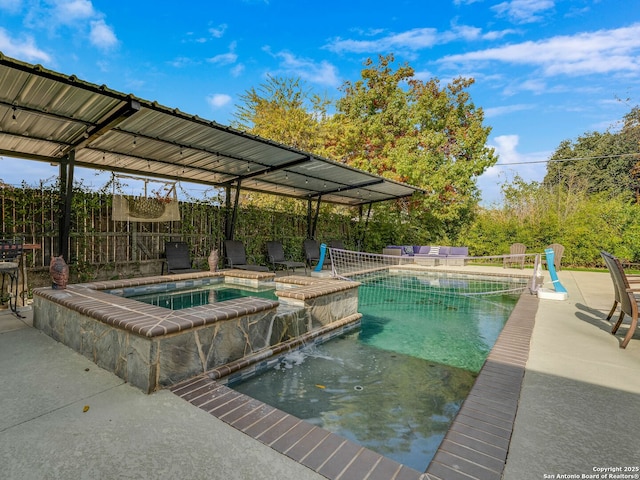 view of swimming pool featuring pool water feature, a patio area, and an in ground hot tub