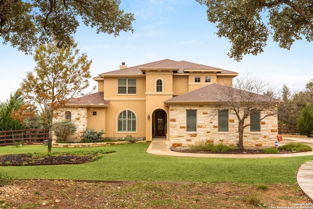 mediterranean / spanish home with a front yard