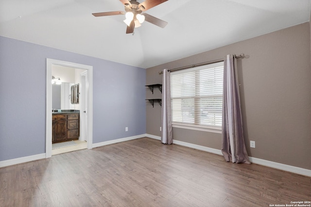 unfurnished bedroom featuring hardwood / wood-style flooring, ceiling fan, and ensuite bath