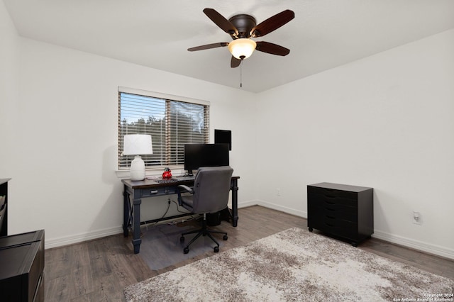 office with dark hardwood / wood-style floors and ceiling fan