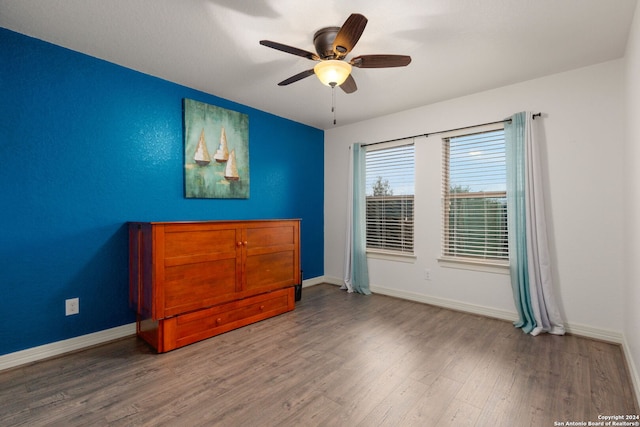 bedroom featuring hardwood / wood-style floors and ceiling fan