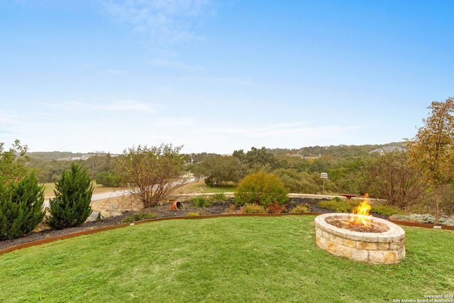 view of yard with an outdoor fire pit