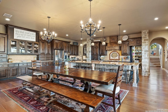 dining area featuring dark hardwood / wood-style flooring and a notable chandelier