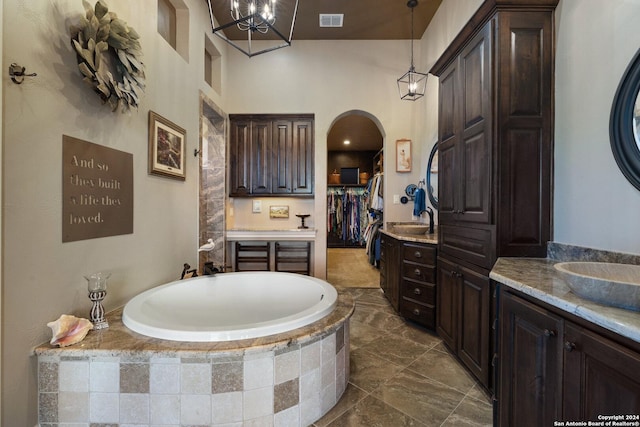 bathroom with a relaxing tiled tub and vanity