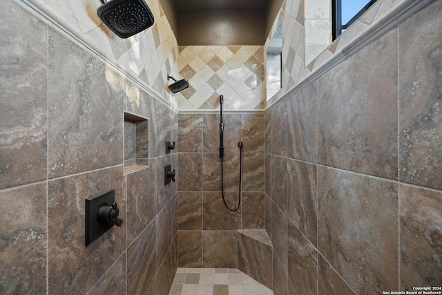 bathroom with tiled shower