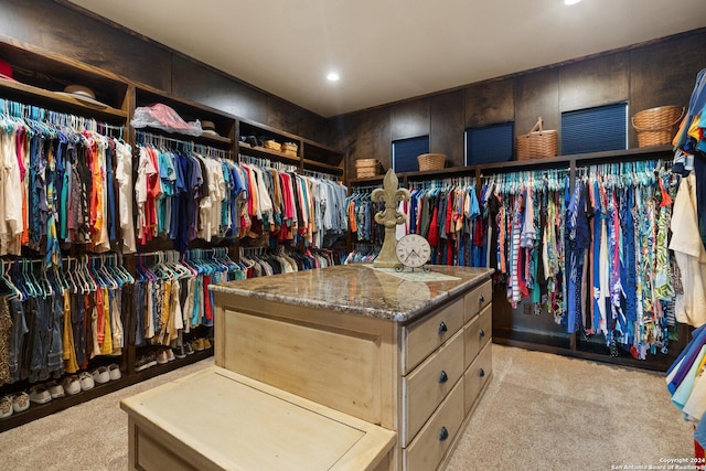 walk in closet with light colored carpet