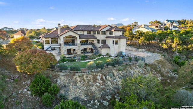 rear view of property featuring a balcony