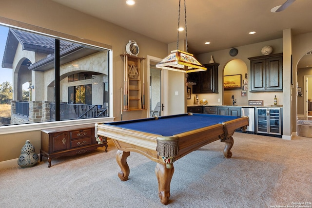 recreation room with light carpet, pool table, beverage cooler, and indoor wet bar