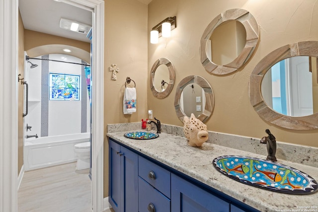 full bathroom featuring vanity, shower / tub combo, and toilet