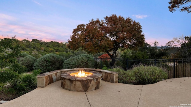 patio terrace at dusk with an outdoor fire pit