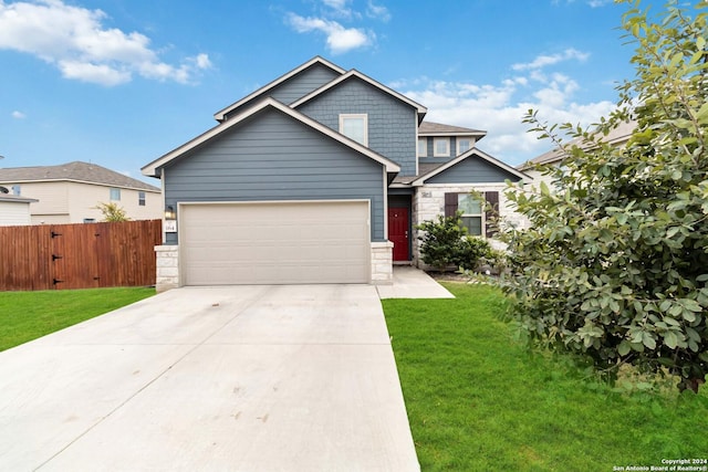 craftsman house with a front yard and a garage