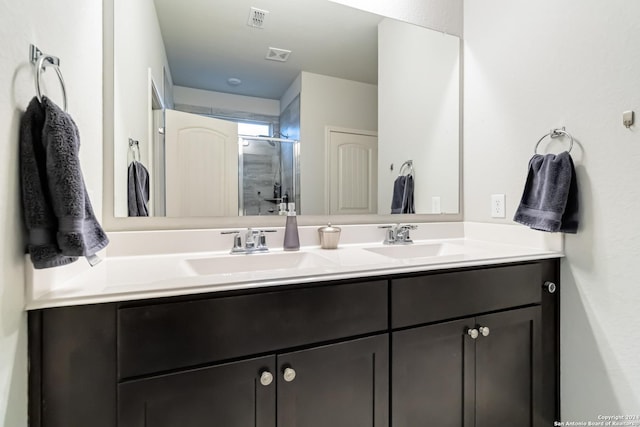 bathroom with a shower with door and vanity