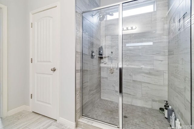 bathroom with a shower with shower door