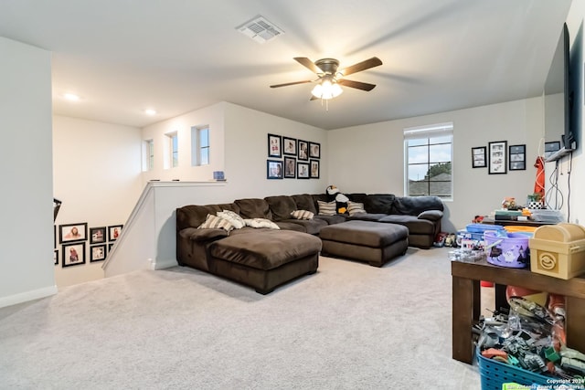 carpeted living room with ceiling fan