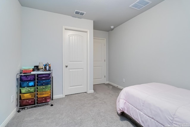 bedroom featuring light carpet