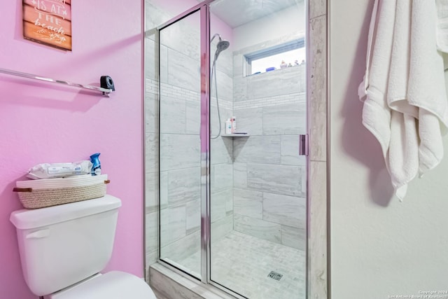 bathroom featuring an enclosed shower and toilet