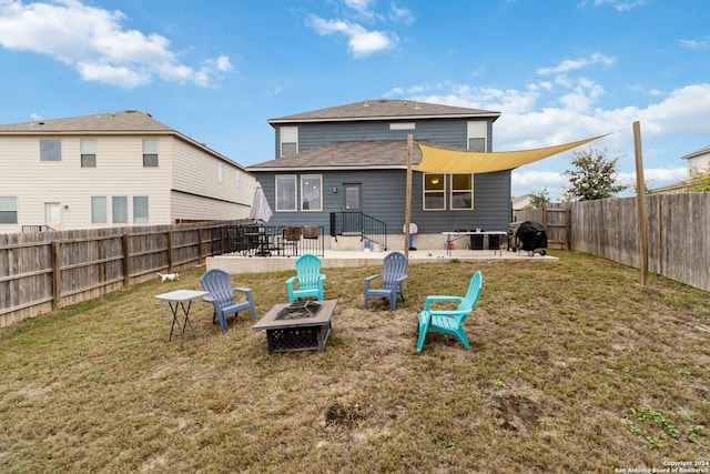 back of house with a lawn, an outdoor fire pit, and a patio