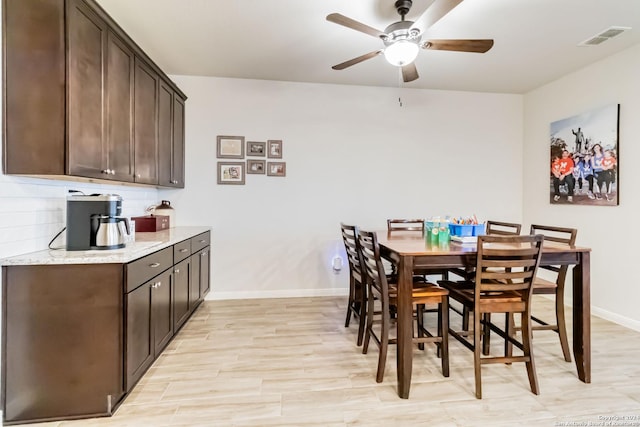 dining room with ceiling fan and light wood-type flooring