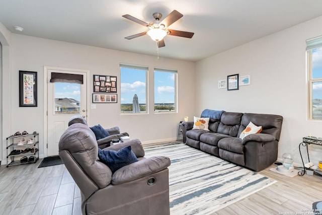 living room featuring ceiling fan and light wood-type flooring