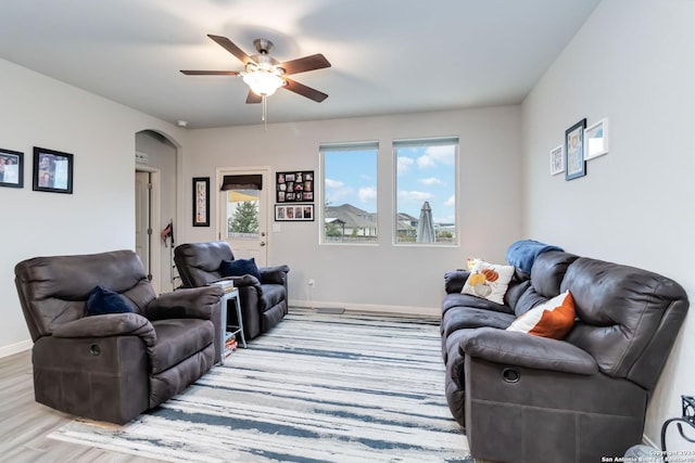 living room featuring ceiling fan and light hardwood / wood-style flooring