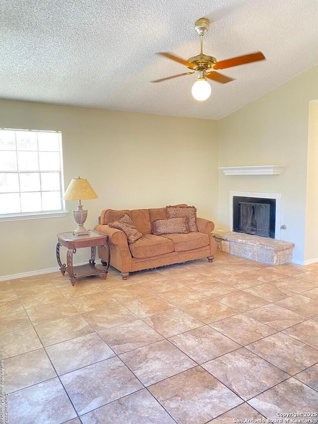 tiled living room featuring ceiling fan and a textured ceiling