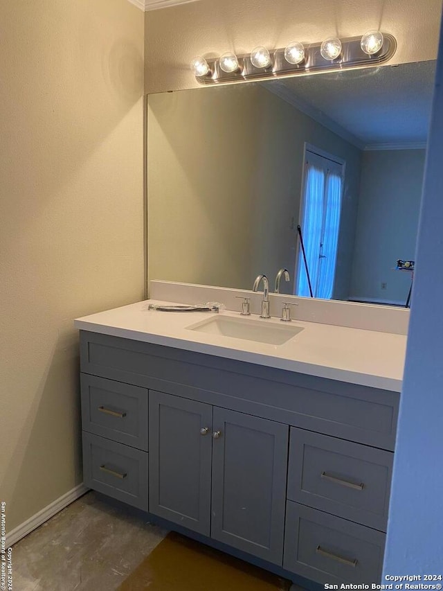 bathroom featuring ornamental molding and vanity