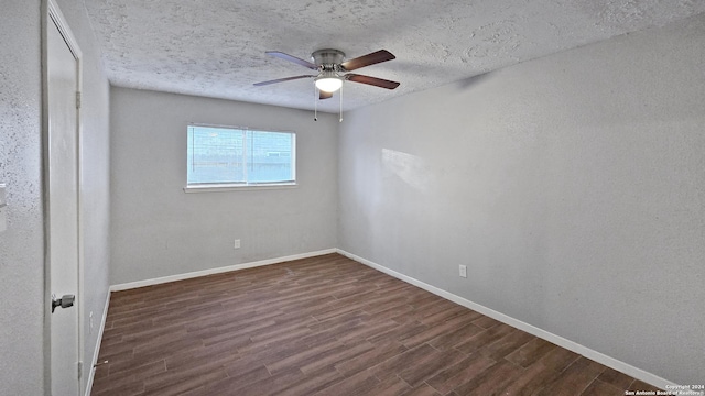 spare room with dark hardwood / wood-style floors, ceiling fan, and a textured ceiling