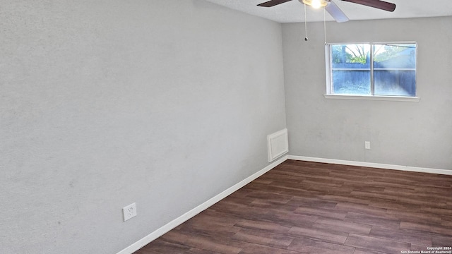 spare room with ceiling fan and dark hardwood / wood-style flooring